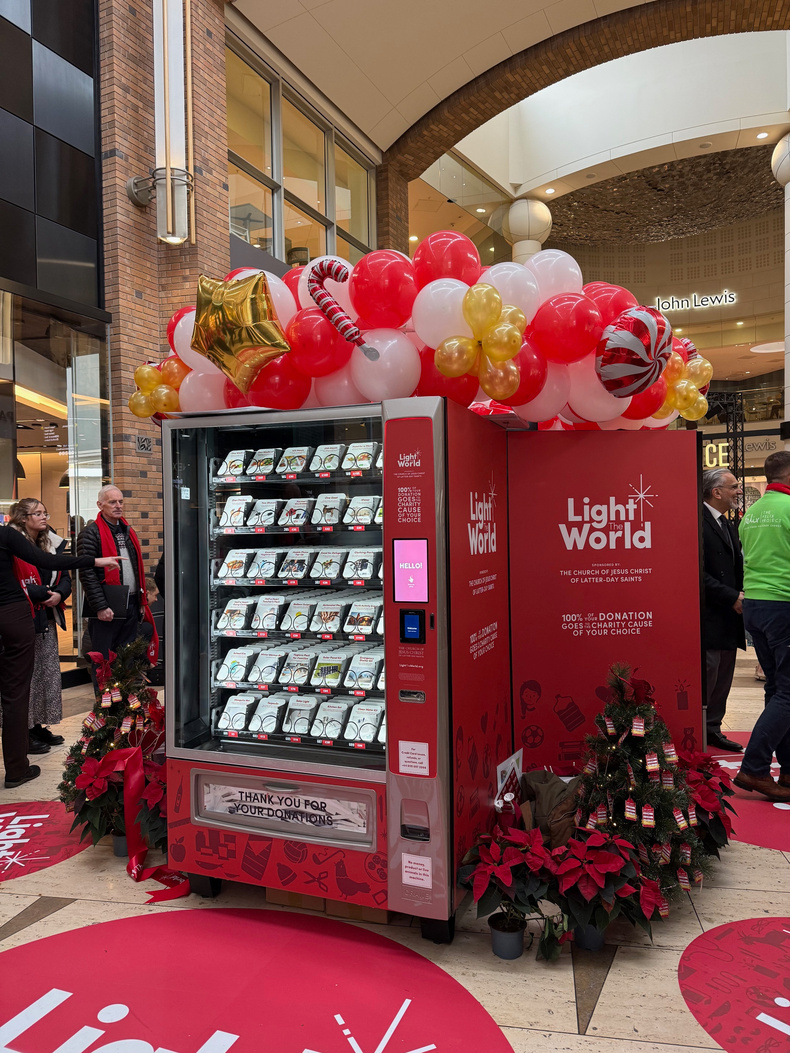 People donating to Light the World vending machine at Touchwood.jpeg